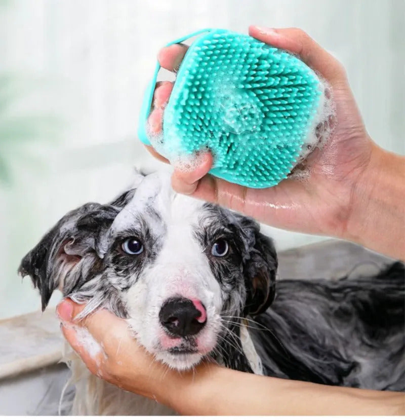 a white and black dog that gets a bath with a dog shampoo scrubber