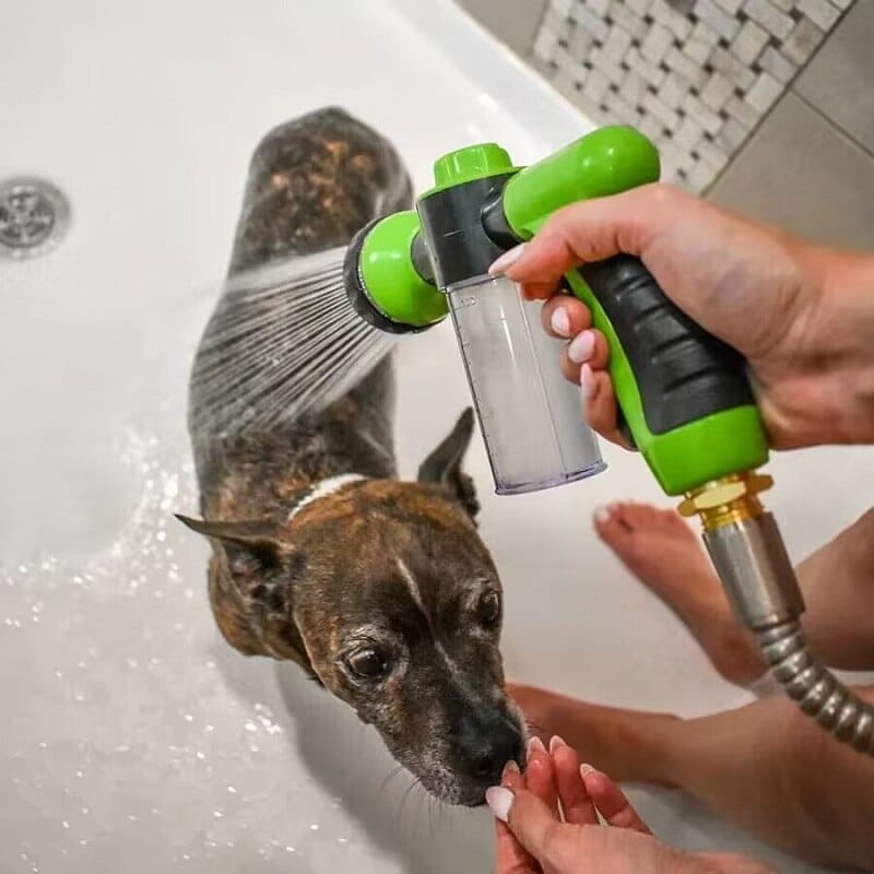 dog is getting cleaned in the bath by a dog washer called pupjet