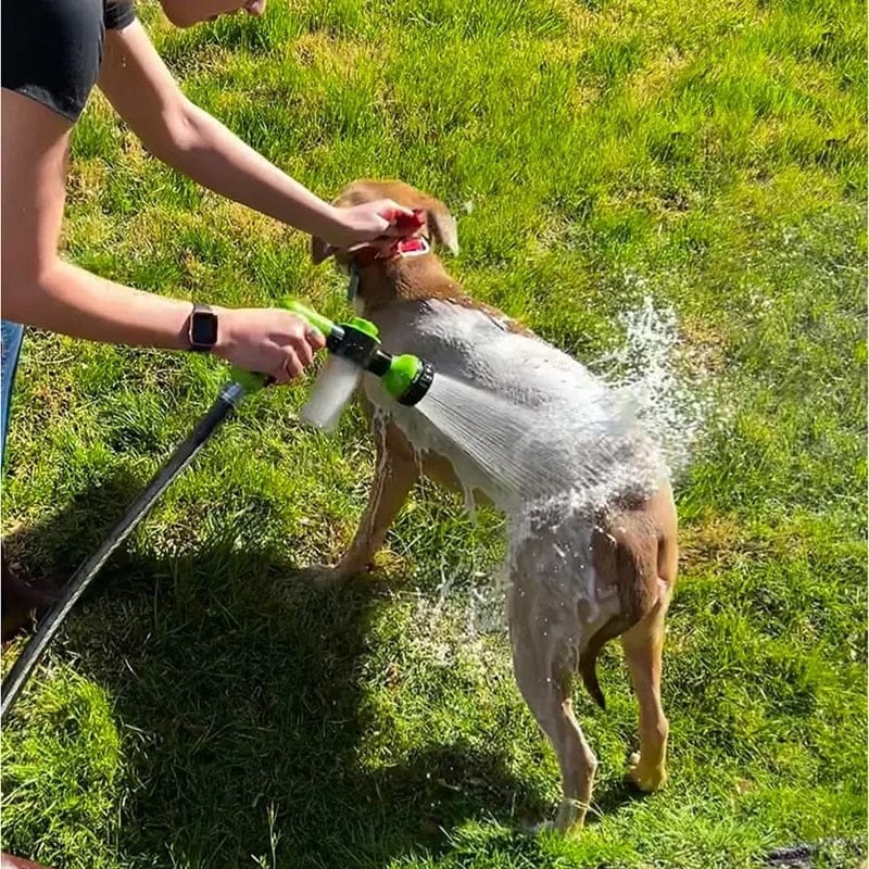 dog getting washed in the yard by a dog washer called pupjet